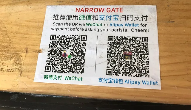 WeChat Pay and Alipay QR codes at a shop counter in China