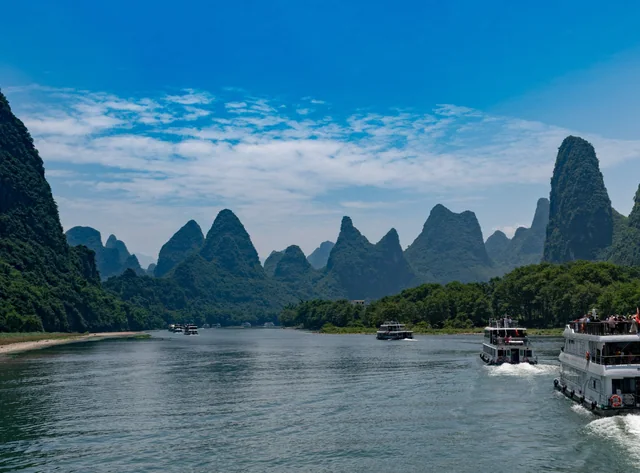 River boats beneath limestone peaks on the Li River in the Guilin region