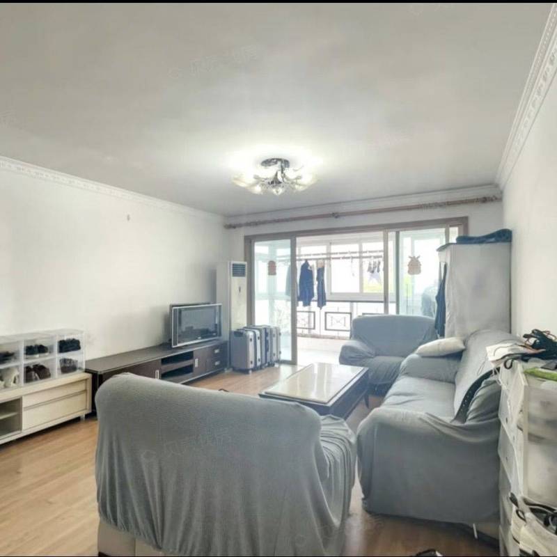 Living room with sofas, a coffee table and balcony windows in the Haiyi Garden advertiser gallery
