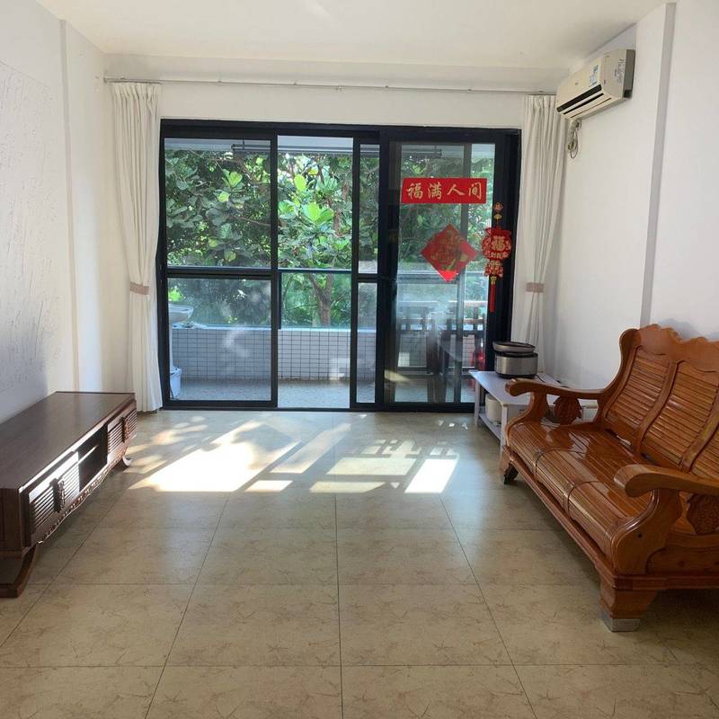 Living room with a wooden sofa and balcony doors in the Peninsula Phase 1 advertiser gallery